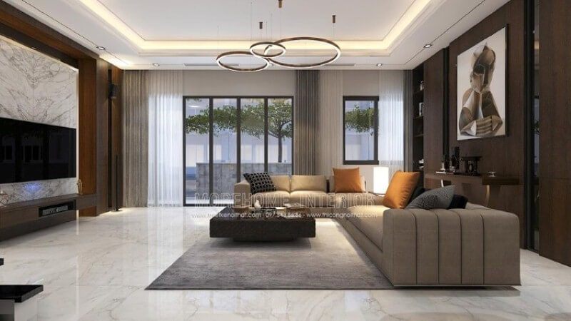 Nội thất phòng khách biệt thự hiện đại cao cấp được lấy cảm hứng từ những tinh túy tuyệt đẹp của tự nhiên. Hệ thống cửa kính trắng lớn luôn mở rộng để chào đón vượng khí từ ngoài. Bố trí nội thất sử dụng chất liệu gỗ kết hợp với đá tự nhiên để tạo nên một bức tranh hoàn hảo.